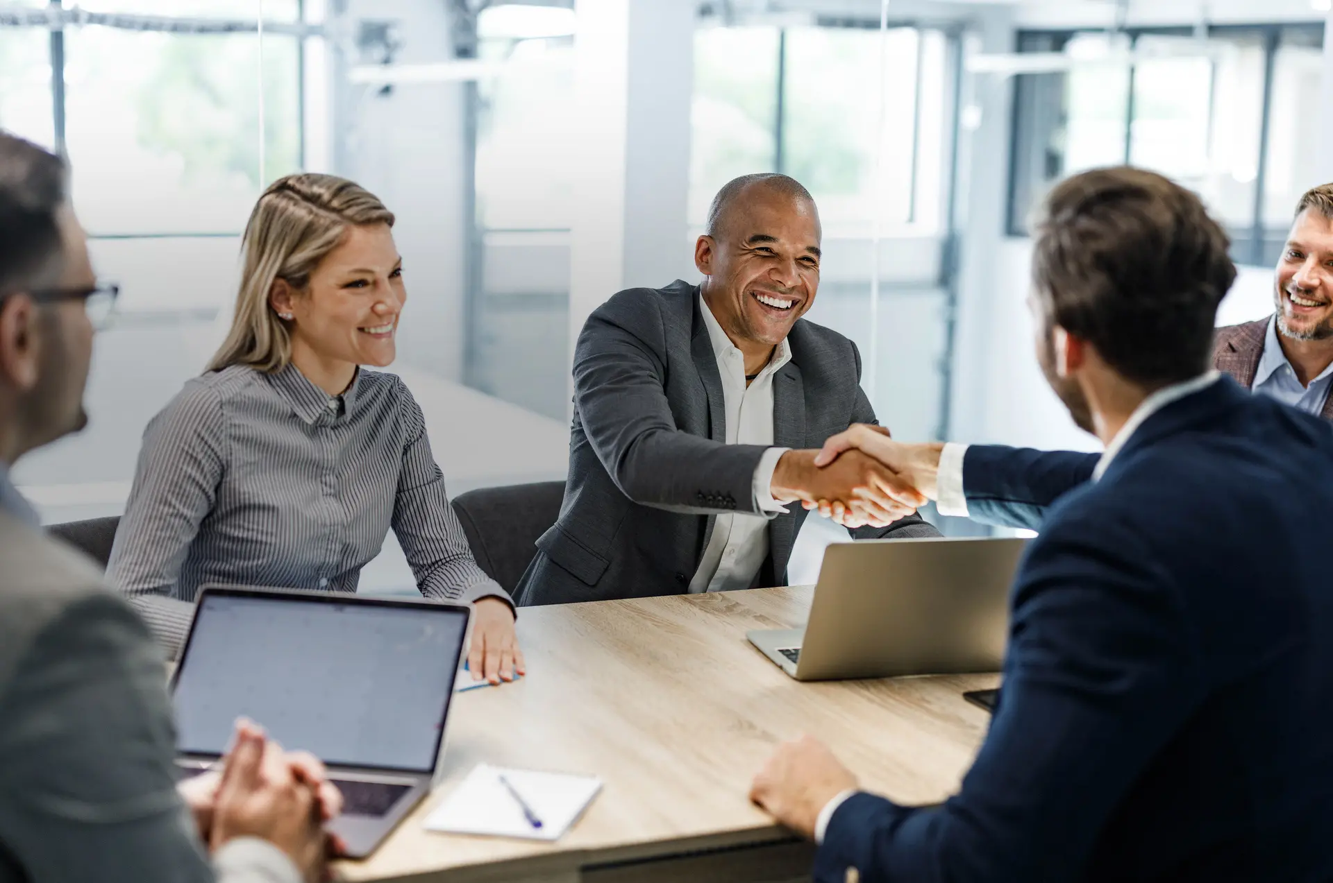 Leerink Partners-MA Advisory Executives shaking hands in a board room